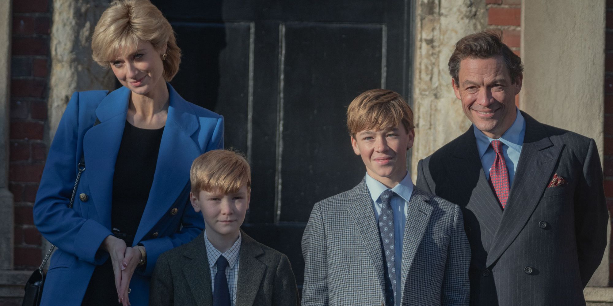 Royal family in front of a doorway looking straight at the camera.