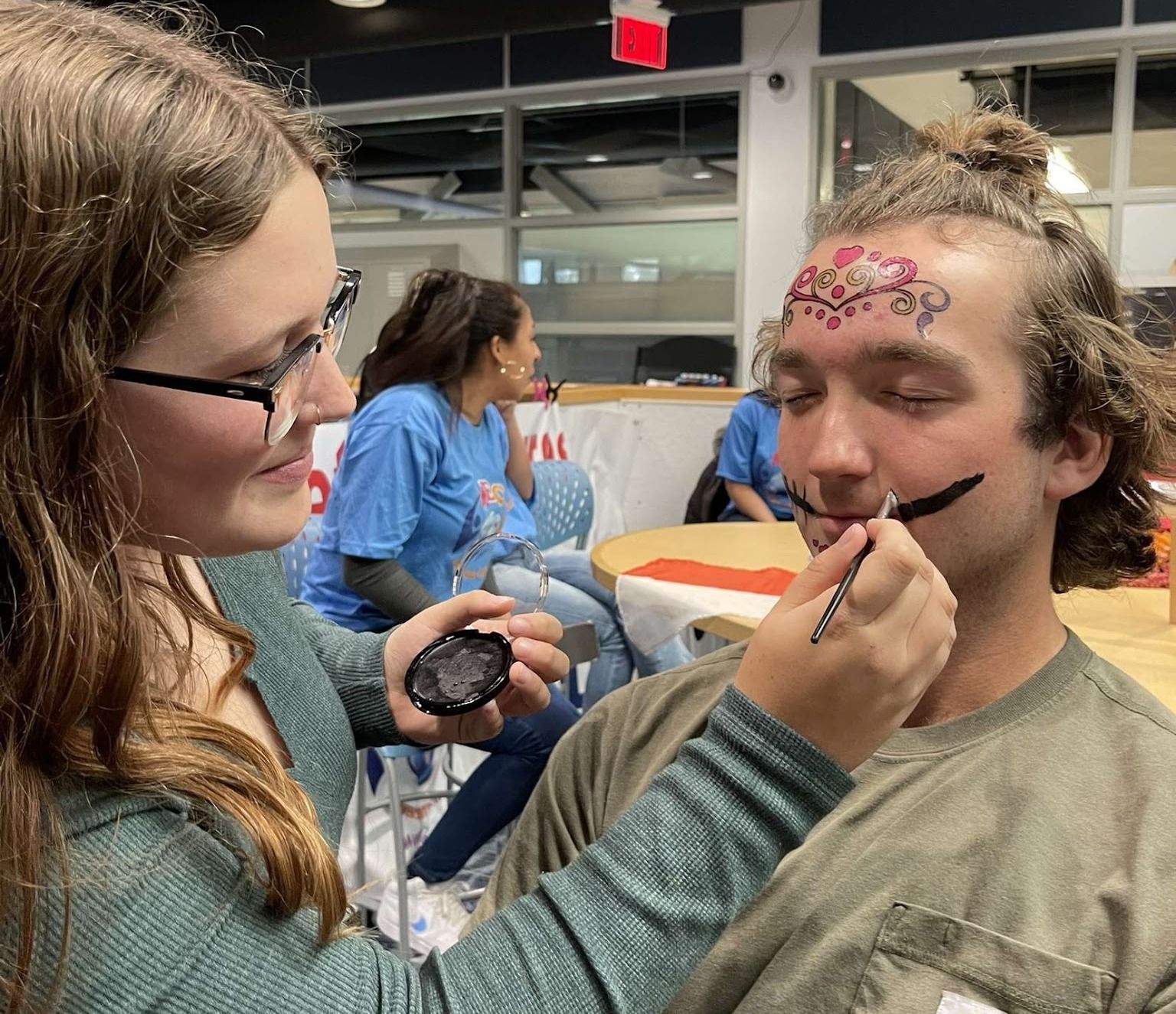 A person has their face painted.